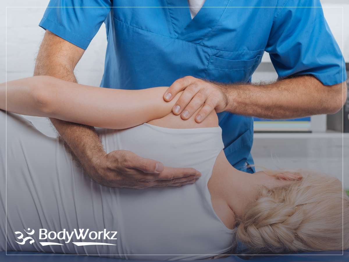 Female patient receiving shoulder adjustment from a Mesa Chiropractor at BodyWorkz clinic."

"Female patient receiving shoulder adjustment from a Mesa Chiropractor at BodyWorkz clinic