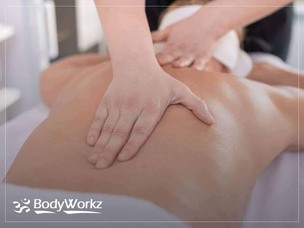 Therapist performing a back massage session at BodyWorkz