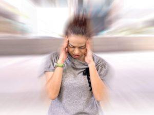 woman with migraine needs chiropractic care