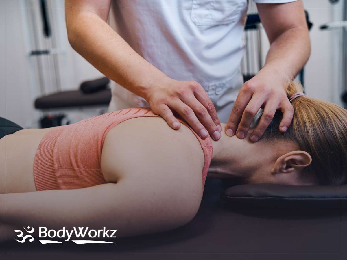 Chiropractor performing an adjustment on a female patient at BodyWorkz clinic