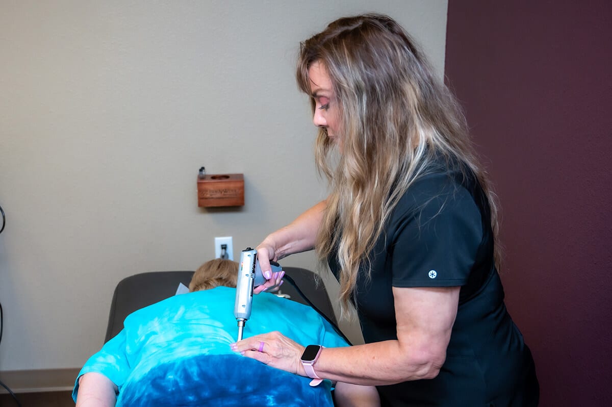 Dr. Marie Cipollo administering spinal treatment to patient in Mesa, AZ