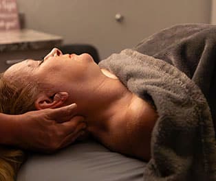 Therapeutic adjustment being performed on a patient for neck pain relief