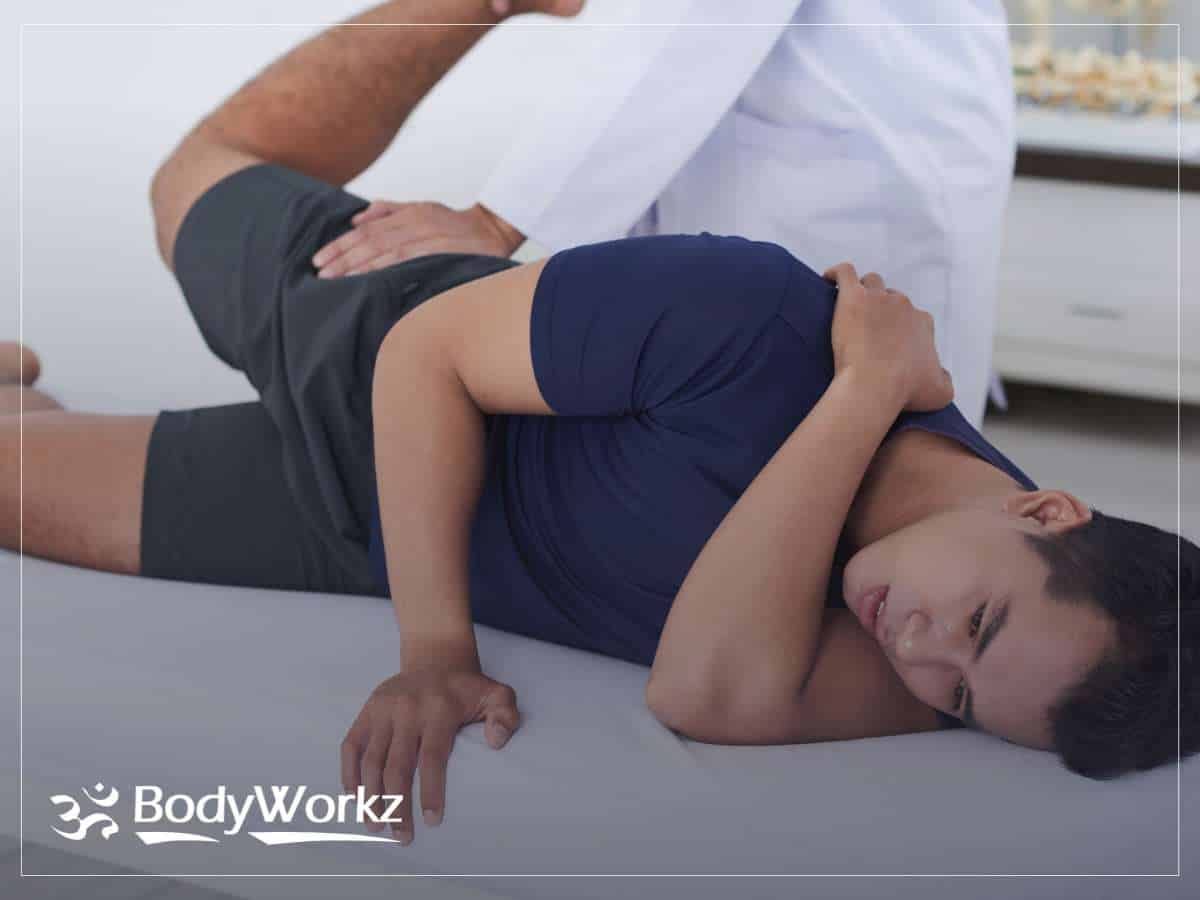 Chiropractor performing an adjustment on a patient experiencing hip pain