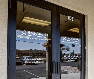 Frontdoor 1 Reception area of BodyWorkz with staff assisting a patient