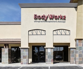 Storefront 1 BodyWorkz chiropractor treating a patient with advanced therapy equipment